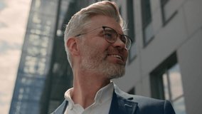 Close up portrait in city outdoors smiling happy mature older business man leader senior businessman carefree middle aged company CEO touch eyeglasses smile looking around outside eyesight eyewear - Powered by Shutterstock - Get 15% off with code: PIKWIZARD15