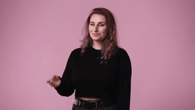4k video of one woman who sweetly thanks for something over pink background.