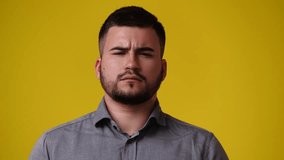 4k video of one man who responds negatively to something over yellow background.
