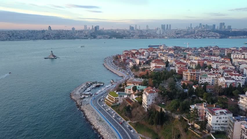 Salacak, Uskudar Region in Istanbul. Traffic on coastal way, parked cars on street and housing along the Bosphorus Sea. Aerial drone Birds eye view establishing shot of the city
