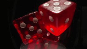 Red dices with white dots thrown into transparent glass illuminated by bright studio light. Gaming cubes with equal points on faces in wineglass on black background macro - Powered by Shutterstock - Get 15% off with code: PIKWIZARD15
