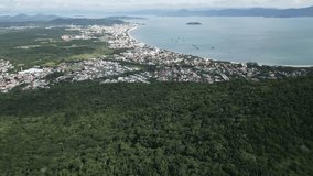 drone footage of of Praia dos Ingleses, on Santa Catarina Island, Florianópolis, State of Santa Catarina, Brazil touristic destination with residential district area for real estate 