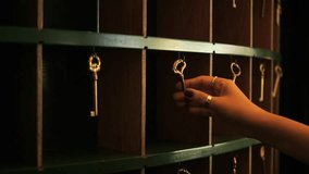 Female Hand Takes Old Room Key from Vintage Style Hotel Reception Rack, 4K Slowmotion Cinematic Travel Mood Concept Footage, Thailand. - Powered by Shutterstock - Get 15% off with code: PIKWIZARD15