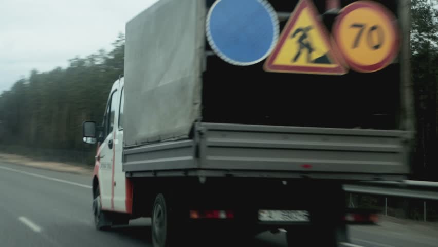 road service vehicle driving on the highway in cloudy weather in spring, background
