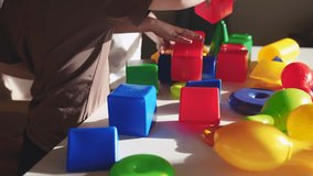 kindergarten close-up. a group of children play toys cubes and cars on the table in kindergarten. happy family preschool education concept. nursery boy baby toddler home indoor - Powered by Shutterstock - Get 15% off with code: PIKWIZARD15