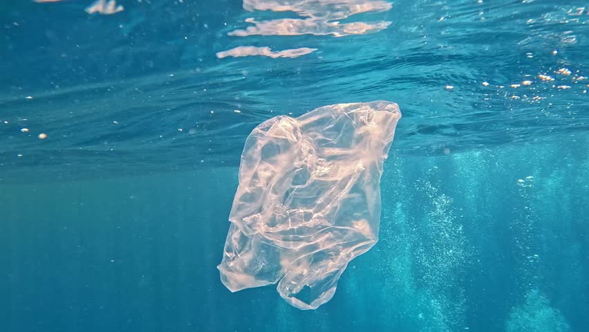 Piece of plastic bag floating in the sea. Danger of free-floating waste to animals. Royalty-Free Stock Footage #1105316527