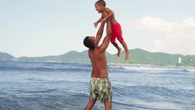 Dad playing and fooling around with his toddler son at the ocean beach having fun. Multi ethnic father playing with his young son at the beach, priceless parenthood moments.
 - Powered by Shutterstock - Get 15% off with code: PIKWIZARD15
