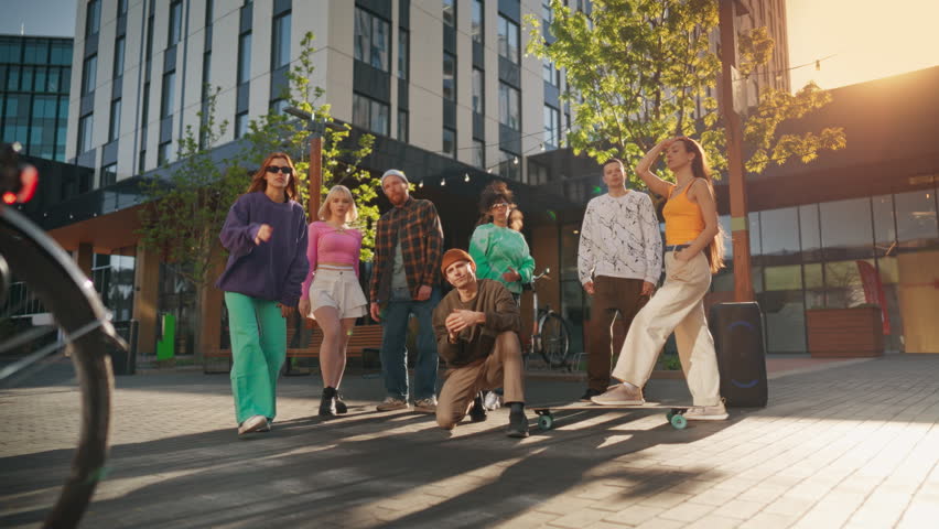 Group Of Young And Stylish Men And Women Posing And Looking At Camera In Slow Motion. Male And Female Fashionable Friends Representing Youth Subcultures. Creative People Hanging Out Together Downtown. Royalty-Free Stock Footage #1105318961