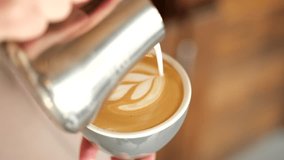 Barista making cappuccino. Barista pouring milk in cap and doing cappuccino art in coffee shop - Powered by Shutterstock - Get 15% off with code: PIKWIZARD15
