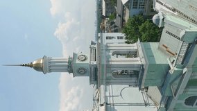 Monastery Heights: Aerial Perspective of Ekaterininsky Greek Monastery Bell Tower from the Ferris Wheel on Kontraktova Square in Kyiv. Vertical UHD Video