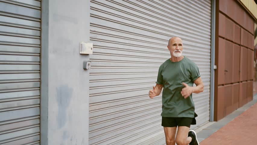 80 years old man making sport and different activities outdoor. Senior man training in the city. Concept about healthy lifestyle and seniority