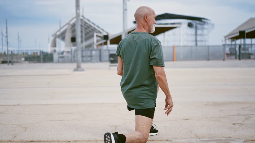 80 years old man making sport and different activities outdoor. Senior man training in the city. Concept about healthy lifestyle and seniority