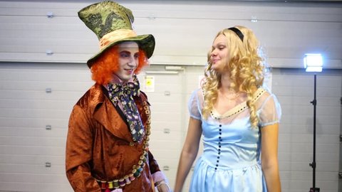 MOSCOW, RUSSIA - OCTOBER 12, 2014: Pair in costumes the Mad Hatter and Alice (Alice in Wonderland) at Everycon in the Exhibition and Convention Centre Sokolniki