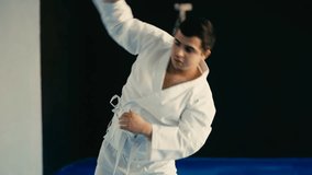 Young taekwondo practitioner warming up before training in gym, combat sport - Powered by Shutterstock - Get 15% off with code: PIKWIZARD15