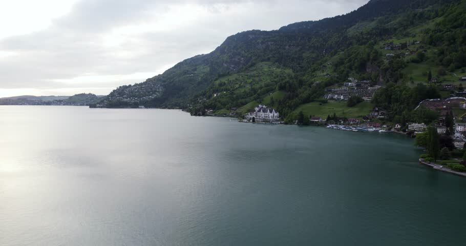 Idyllic View Of The City And Alps Mountains In Lake Lucerne, Central Switzerland. Aerial Wide Shot