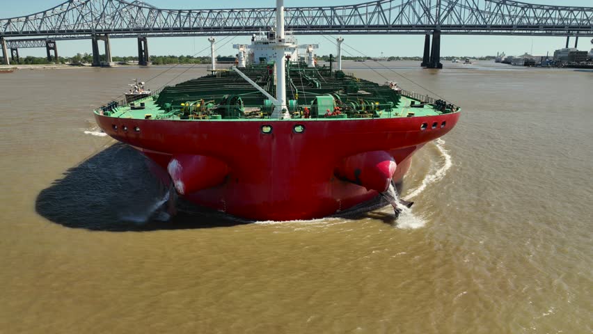 Aerial reverse reveal of the Mississippi River, tanker and the Mississippi River bridge near New Orleans...