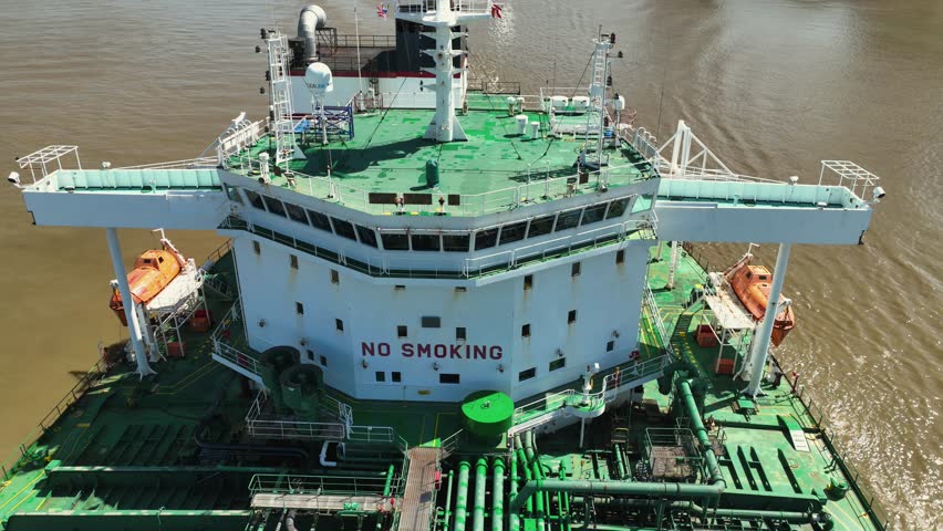 Aerial reverse reveal of ship on the Mississippi River near New Orleans