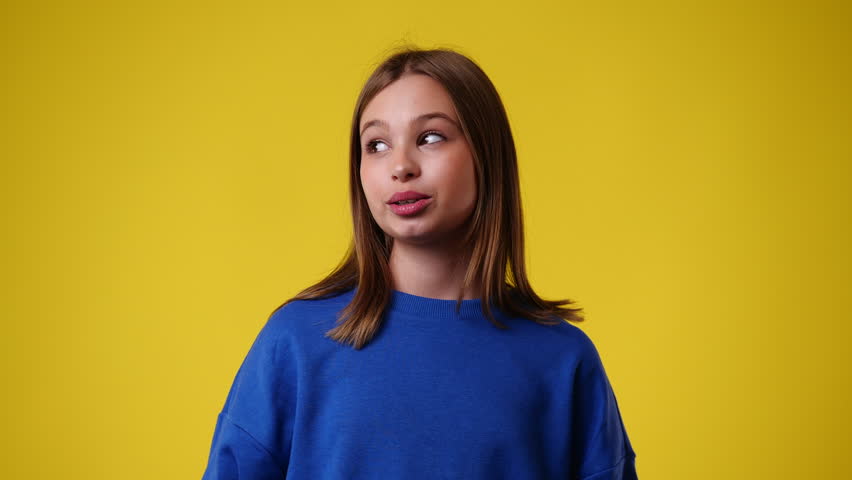 4k slow motion video of one girl showing silence sign over yellow background. Royalty-Free Stock Footage #1105336715