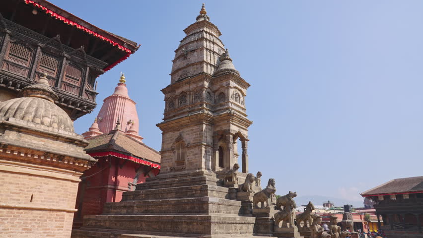 Stone Guardians on the stairs to the Siddhi Laxmi Temple on a sunny day with no tourists, Durbar Square of Bhaktapur, Nepal