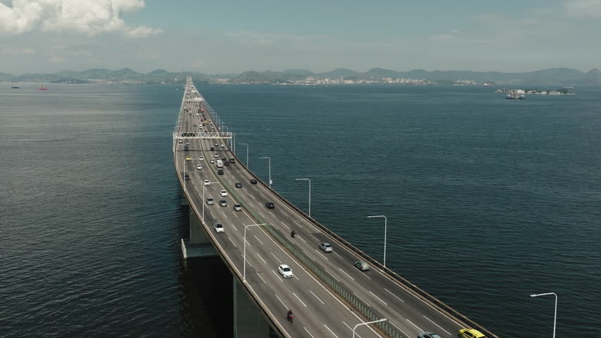 Aerial circular view highway Bridge over the ocean lead to city of Rio de Janeiro, Brazil. Modern architecture bridges and traffic, transportation, tolls concept Royalty-Free Stock Footage #1105338777