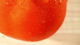 The movement of the water droplets can be a captivating aspect of the macro video. They may slowly roll or slide down the tomato's curved surface, making the video come alive. Tomato background
