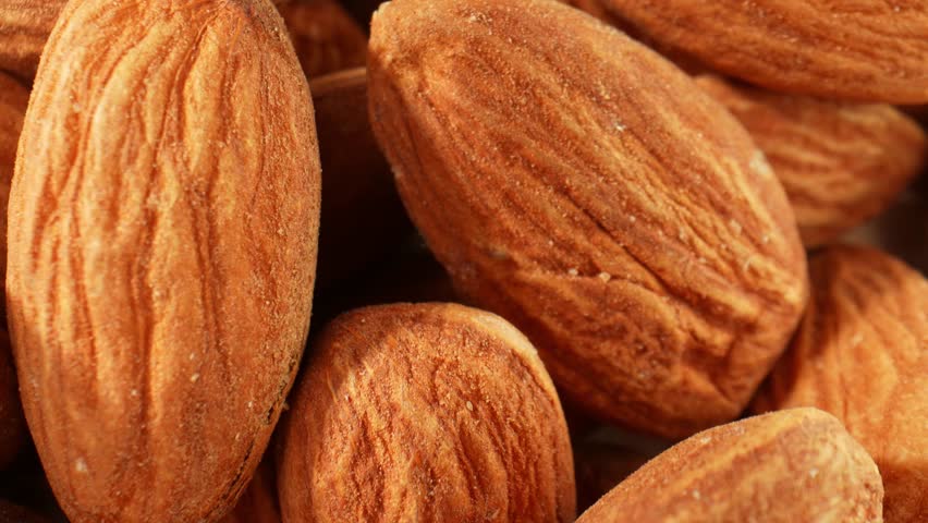 The macro video offers a visual exploration of almond kernels. It celebrates the natural elegance and complexity of these small, nutritious wonders. Food and snack concepts. Almond background. 4K
