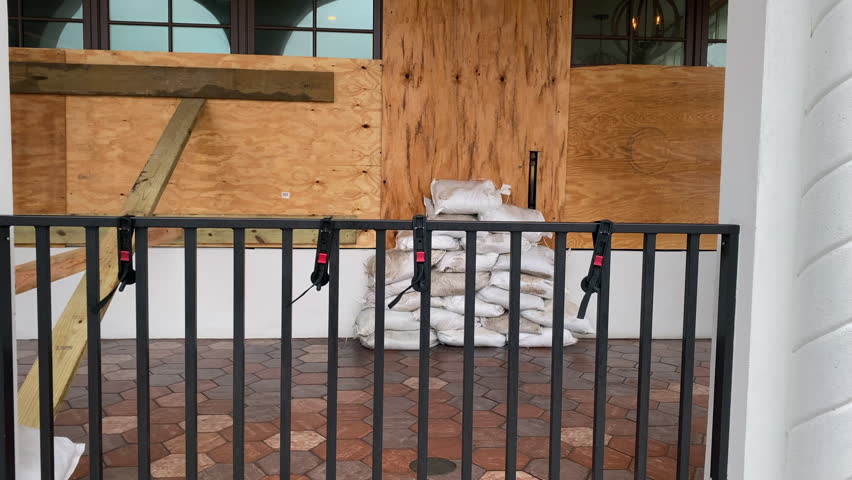 Restaurant boarded up with sandbags preparing for hurricane flood waters Royalty-Free Stock Footage #1105345209