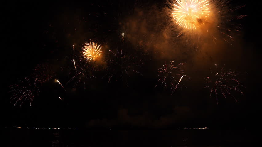 Real fireworks background. Firework Display,  abstract blur of real golden shining fireworks lights at night sky. glowing fireworks show. Firework Explosive Material. New year's eve fireworks. Royalty-Free Stock Footage #1105346757