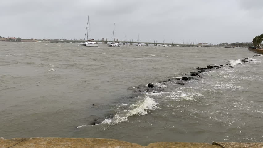 Hurricane water surges over flood barrier as storm makes landfall, Florida