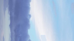 A timelapse captures the movement of fluffy clouds in a peaceful blue sky. Vertical video. - Powered by Shutterstock - Get 15% off with code: PIKWIZARD15