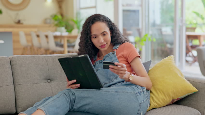 Home, ecommerce and woman with a tablet, credit card and online shopping with transactions, connection and happy. Female person, excited customer or girl on a sofa, technology or payment with banking