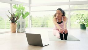 Laptop, forward stretching and woman in home for exercise, fitness or holistic training. Computer, yoga and female person in pose streaming pilates video, online class or tutorial for healthy body.