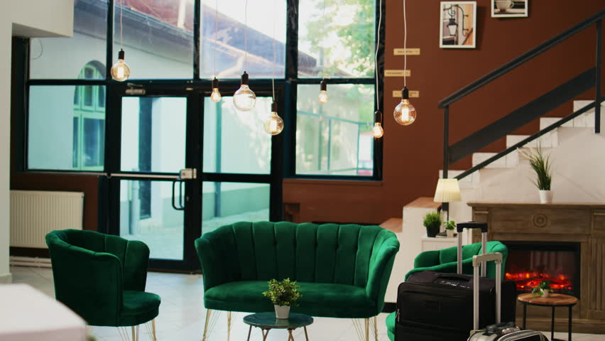 Empty hotel reception and lobby with lounge area, modern classy furniture and interior deisgn. Stylish luxurious tropical resort with front desk counter, elegant decor and plants.