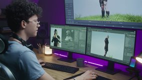 Young 3D designer draws video game character, creates animation. Teen trains 3D modeling and game development at home on computer and big digital screen with professional program interface for design.