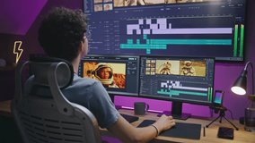 Young video maker edits sound tracks for movie about space mission, works at home office. Film footage and software interface with tools on computer and big digital screen. Concept of post production.