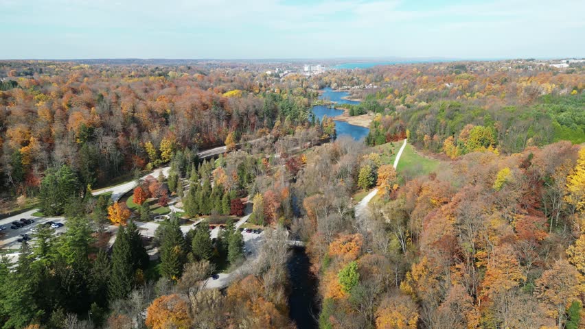 Drone flying over a river on a sunny autumn day in Ontario.