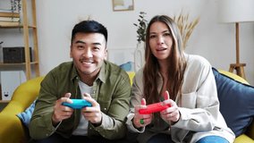 Multiracial couple playing video games together.