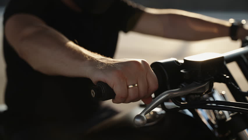 The throttle stick on the motorcycle. A man's hand twists the fuel supply drosel on the bike. Motorcycle detail. Summer hobbies on bikes. Royalty-Free Stock Footage #1105370791