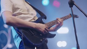 Electric bass guitar player hands. Guitar and guitarist. Live music. Close-up