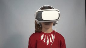 4k girl at home in virtual reality VR glasses watching video, playing games