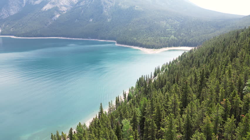 Cinematic Drone shot, lake Minnewanka, forest, Banff national park, Alberta, Canada