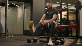 African American unwell man sad suffering with knee pain in sport club workout trauma sporty man muscle ache sportsman athlete male injuring leg in training painful injury in fitness gym ache damage - Powered by Shutterstock - Get 15% off with code: PIKWIZARD15