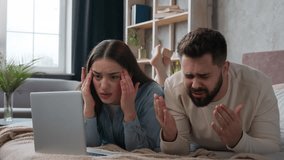 Caucasian upset couple husband wife worried shocked disappointed bad news loss negative result breakdown laptop internet service displeased woman girl and man guy in bedroom computer addicted failure - Powered by Shutterstock - Get 15% off with code: PIKWIZARD15