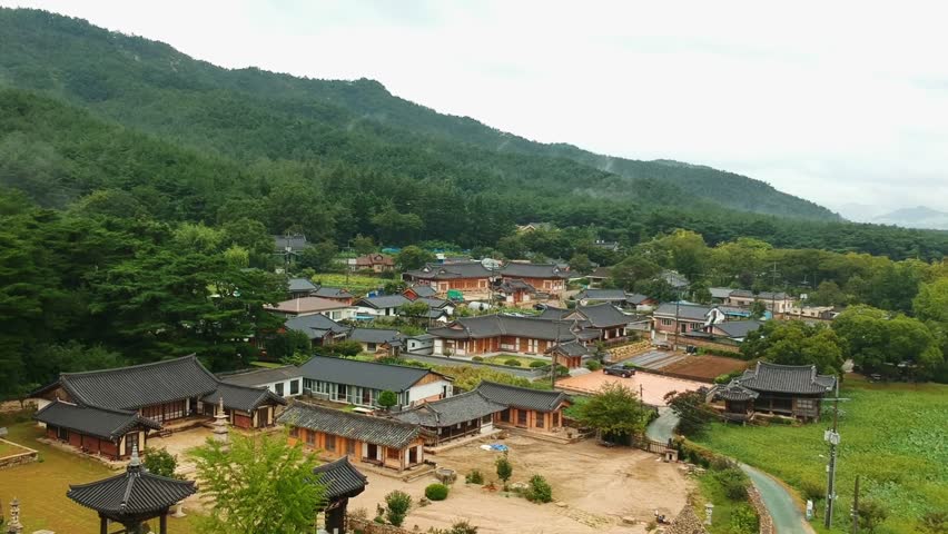 Aerial view of a rural area with traditional korean houses. Drone view with mountains background in South Korea
