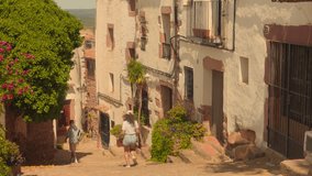 Couple walking in summer in an old village in Spain - HD video - Powered by Shutterstock - Get 15% off with code: PIKWIZARD15