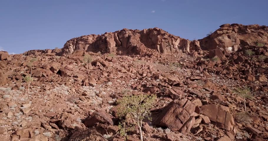 4K Aerial drone footage of Twyfelfontein area in Namibia, Africa. African ancient rock formations, red rock landscape. Hiking. Cinematic High quality footage. Royalty-Free Stock Footage #1105375545