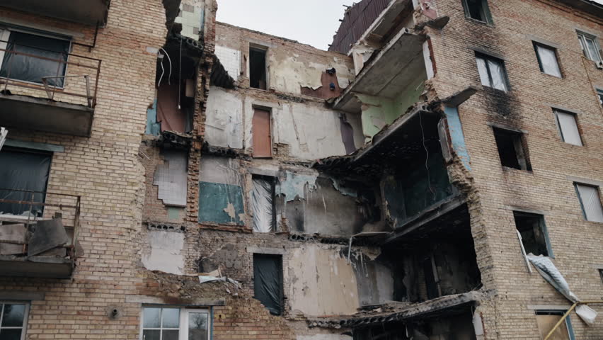 missiles damage, Gray debris, destroyed city. War-damaged building, part of scene of collapse of building in Ukraine, debris, dust and damaged house were left behind as consequence of bombing.