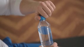 opening a bottle of water. close-up. a man opens a bottle of water. High-quality Full HD video recording