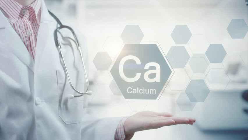 Pharmacy expert doctor showing symbol for the chemical element and mineral Calcium Ca. Clean abstract commercial background