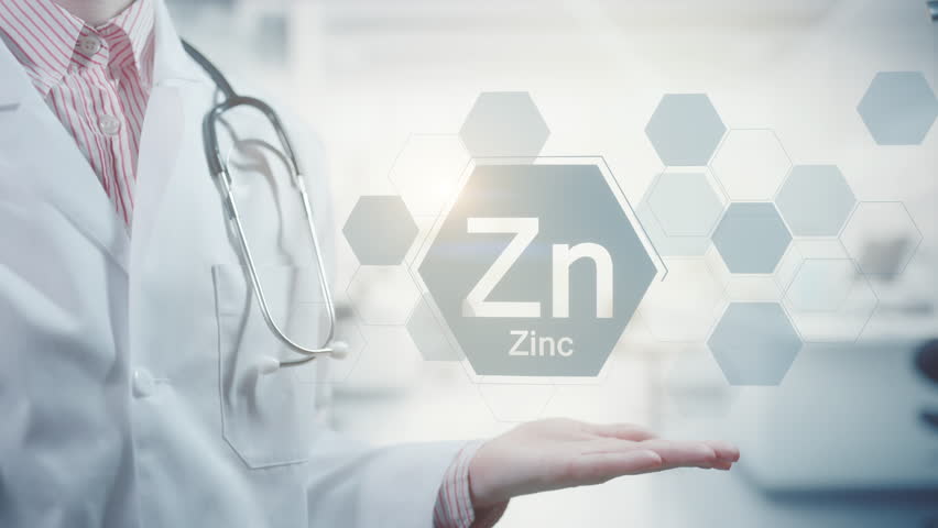 Pharmacy expert doctor showing symbol for the chemical element and mineral Zinc Zn. Clean abstract commercial background